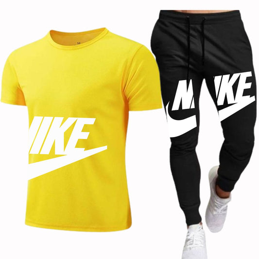 A tracksuit with a half sleeve yellow t-shirt and black pants with a large white 'IKE' logo on the shirt and pants.